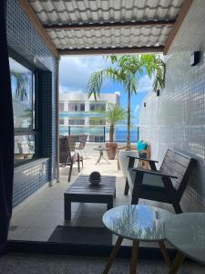 a room with a patio with a view of the ocean at Cobertura Duplex Luxo in Salvador