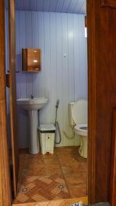 a small bathroom with a sink and a toilet at Amazon Boto Lodge Hotel in Careiro