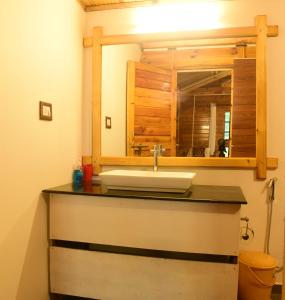 a bathroom with a sink and a mirror at Rockit Cafe & Stay in Palolem