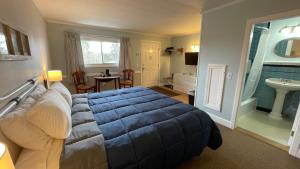 a bedroom with a large bed and a bathroom at Bucksport Inn in Bucksport