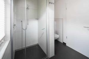 a bathroom with a shower and a toilet at Utspann in Norderney