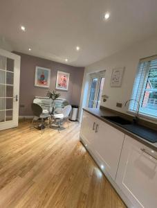 a kitchen and dining room with a table and chairs at Modern + Secluded 3 bed, 10 mins into city centre in Spixworth
