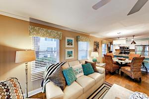 a living room with a couch and a dining room at Pawleys Island in Pawleys Island