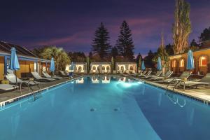 a large swimming pool with chairs and umbrellas at Surrey Resort and Gym in Guerneville