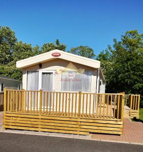 a small kiosk with a fence in front of it at Hiker's Den, Brigham, Cockermouth, Cumbria in Cockermouth