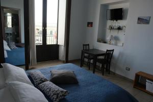 a bedroom with a bed with pillows on it at Jonio B&B in Acireale