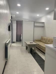 a living room with a couch and a table at Kakha's Apartment in Batumi