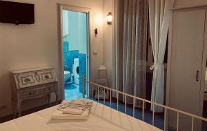 a bedroom with a bed with two towels on it at Sun&SeaGuestHouse Lido di Roma in Lido di Ostia