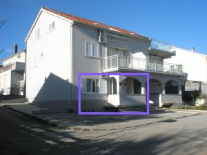 a large white building with a purple frame in front of it at Violet Red Yellow Apartments in Korčula