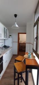 a kitchen with a table and chairs in a room at Casa Salitre in Hermigua
