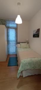 a bedroom with two beds and a large window at Casa Salitre in Hermigua