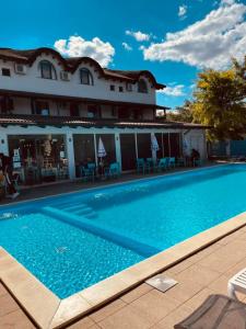 a large swimming pool in front of a building at Pensiunea Pelicanul in Dunavăţu de Jos