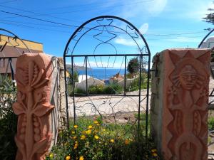 a gate with a view of the ocean behind it at Hotel La Cupula in Copacabana