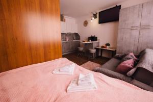 a bedroom with a bed with two towels on it at Найкраще розташування у місті Нові smart-квартири in Uzhhorod