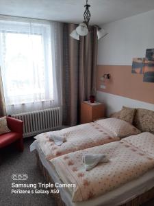 Cama ou camas em um quarto em Hotel Vagónka