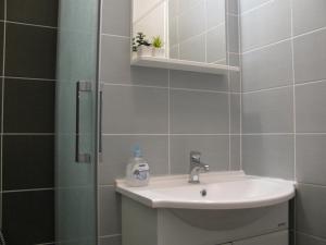 a bathroom with a sink and a shower at Apartments Piacun in Sućuraj