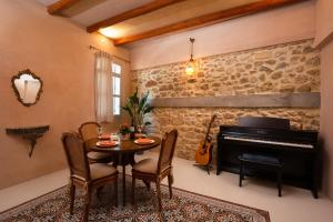 ein Esszimmer mit einem Tisch und einem Klavier in der Unterkunft Casa Emiliana in Rhodos (Stadt)