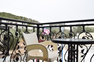 a balcony with a table and chairs on a balcony at Hotel Alexandra in Skala