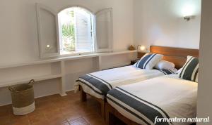 En eller flere senge i et værelse på Casa Lilu Playa Migjorn - Formentera Natural