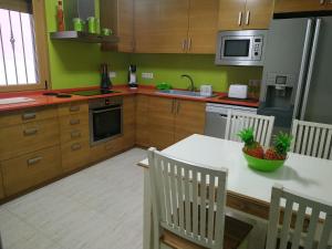 a kitchen with a table with a bowl of fruit on it at PROALMAR, chalet 17 in Peñíscola