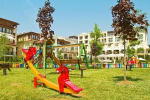 a playground with a slide in a park at Green Life Beach Resort Apartment in Sozopol