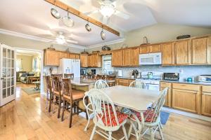 a kitchen with wooden cabinets and a table and chairs at Beautiful Spacious Beach Home, Private Deck & Grill, with Beach Badges in Point Pleasant Beach
