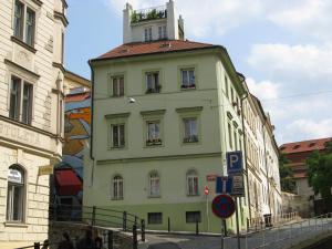 a yellow building with a tower on top of it at Zderaz in Prague