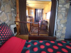 a room with a stone wall and a room with a bed at La loma del chivo Llc Stone Cottage alternative building in Marathon