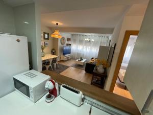 a kitchen with a microwave and a living room at San Agustin Centro in Logroño