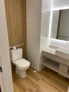 a bathroom with a toilet and a sink and a mirror at RESORT PRAIA DOS CARNEIROS in Tamandaré +7 photos