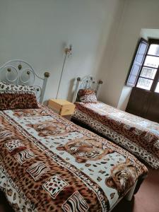 מיטה או מיטות בחדר ב-Hostal La Realeza