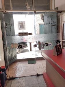 a glass door in a room with a window at Hostal La Realeza in Potosí