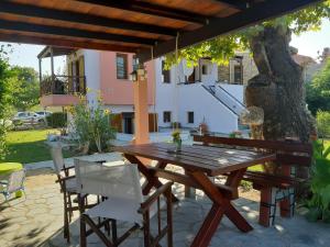 a wooden table and chairs on a patio at Evgenia Maisonette in Ierissos