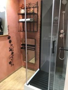 a shower with a glass door in a room at "La chambre des TISSERANDS" in Ménil-Hubert-sur-Orne