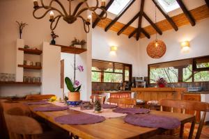 a dining room with a wooden table and chairs at Clavellino House en Villa de Leyva - Tranquilidad y Naturaleza en Reserva Natural Urbana! in Villa de Leyva
