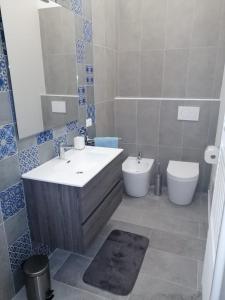 a bathroom with a sink and a toilet at Olly&Asia home in Imola