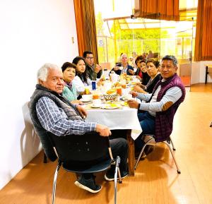 Un groupe de personnes assises autour d'une table à manger dans l'établissement Hotel Plaza San Antonio Arequipa, à Arequipa