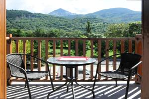 a table and two chairs on a balcony with a view at Chardín de Llum-Apartamentos Chardins in Benasque