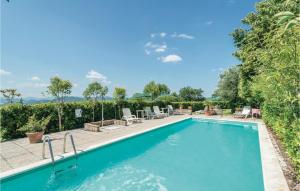 a swimming pool with chairs and a patio with at Paucca 2 in San Valentino di Villa +19 photos