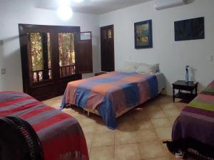 Säng eller sängar i ett rum på Casa Cajueiro em Pipa