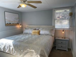 a bedroom with a bed and a ceiling fan at The Hideaway in Downtown Brevard in Brevard