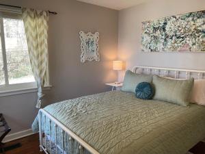 a bedroom with a bed and a painting on the wall at The Hideaway in Downtown Brevard in Brevard