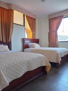 En eller flere senger på et rom på Hotel Dubai Ambato