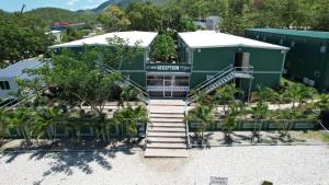 a building with stairs leading up to a building at Green Hills Accommodation Village in Port Moresby