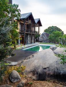 a house with a swimming pool in front of it at Rock Wild Yala in Yala