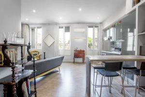 a kitchen and living room with a couch and a table at Superbe T2 de Standing au Pharo - Air Rental in Marseille