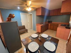 a kitchen with a wooden table with white plates on it at StarFish Apartment in Six Huts +11 photos