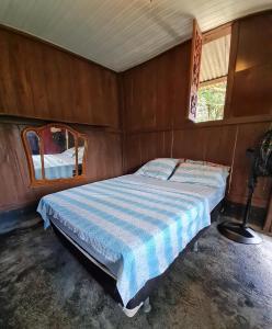 a bedroom with a bed and a mirror in it at Pousada Amazônia Encantada in Iranduba