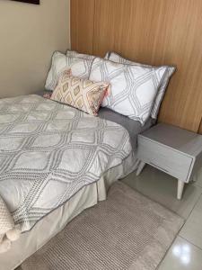 a bedroom with a bed and a side table at Best Value Q Condo1439 in Manila