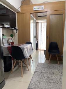 a kitchen with a table and chairs in a room at Best Value Q Condo1439 in Manila